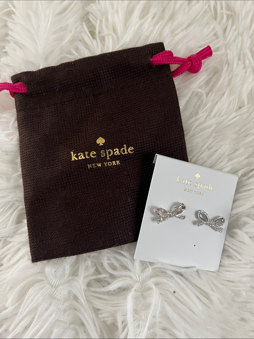 kate spade silver bow stud earrings with pink drawstring pouch